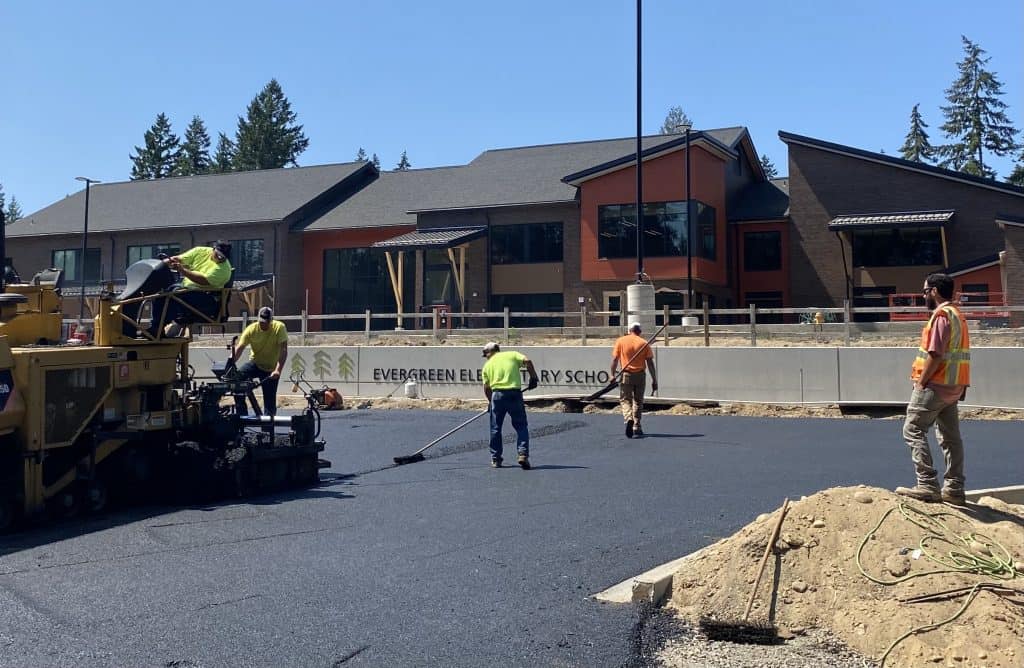 Workers pave the parking lot at the new Evergreen Elementary School on Key Peninsula