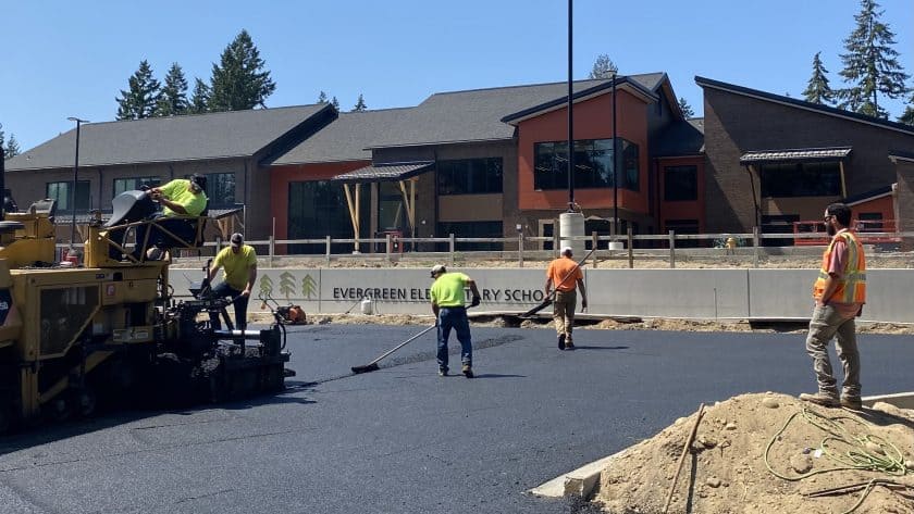 Workers pave the parking lot at the new Evergreen Elementary School on Key Peninsula