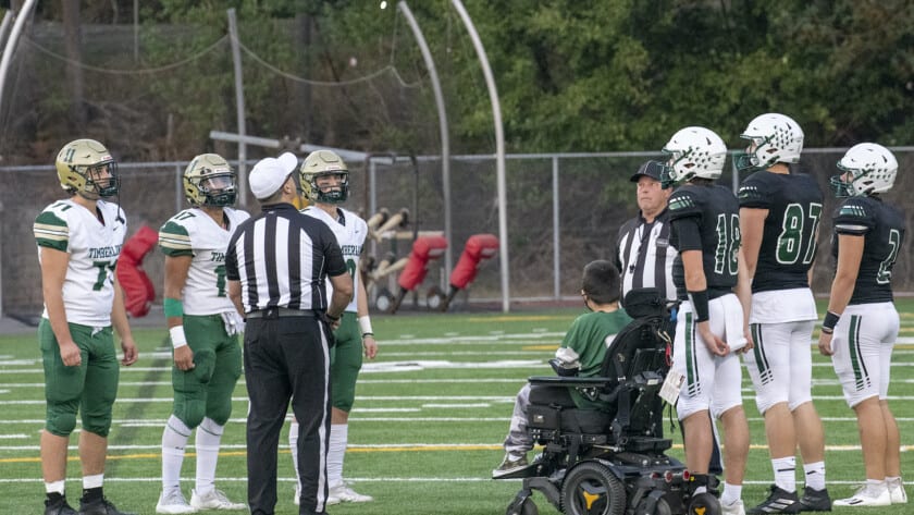 Micah Hester and team captains from Peninsula and Timberline watch the coin flip before Friday's game.