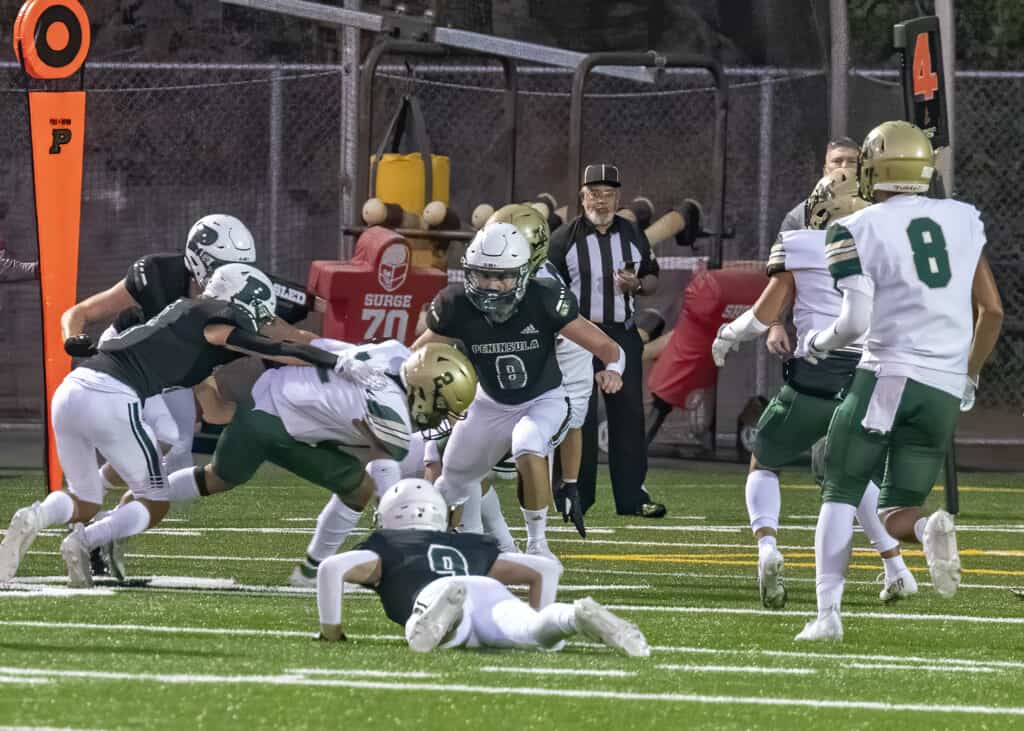 Seahawk defenders, including Jones Stalker (8) and Payton Knowles (9) converge on Timberline’s Franco Segura (2).