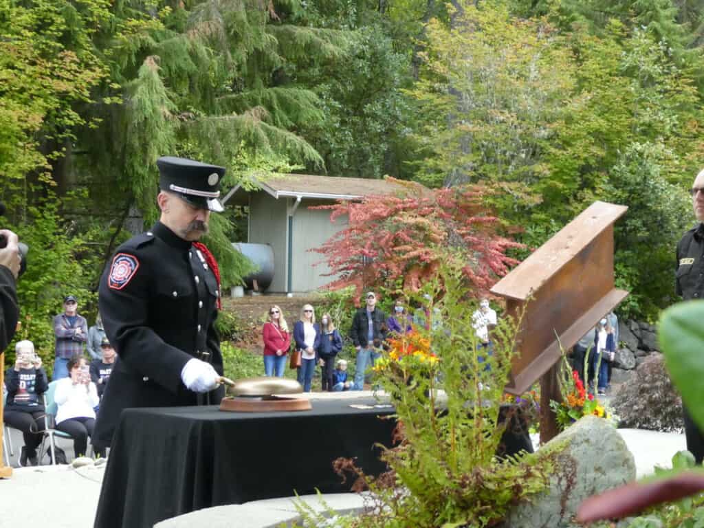 Firefighter Paramedic David Hughes rings the bell to symbolize that the fallen heroes are “going home."