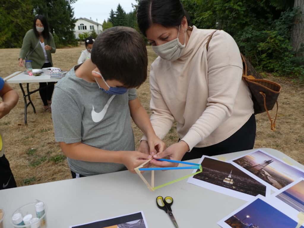 Fourteen-year-old Andrew Dersham gets some help from his mom, Randi Dersham, as he’s building his tower.