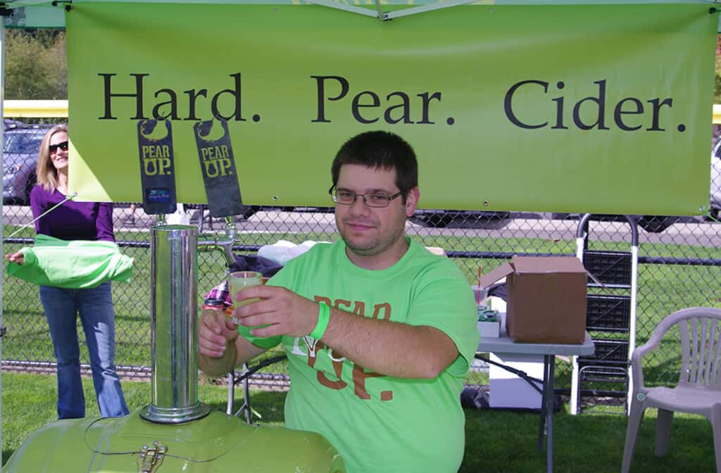 A cider tender pours a drink at a previous Cider Swig event.