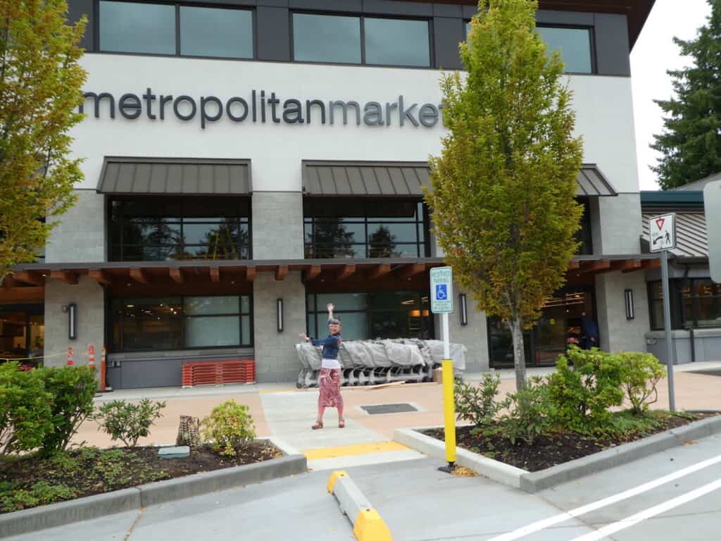 Ginger Henderson displays the front of the new Metropolitan Market that she will manage.