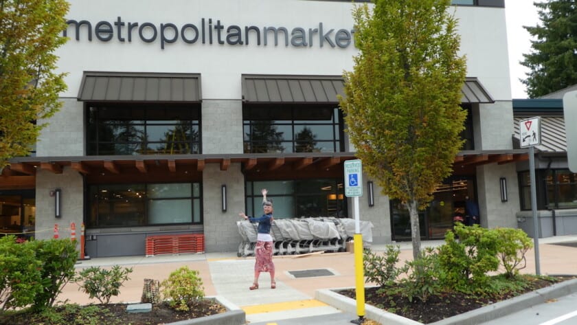 Ginger Henderson displays the front of the new Metropolitan Market that she will manage.