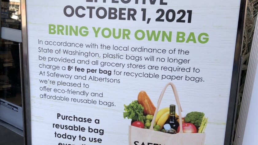 A sign outside of the Gig Harbor Albertsons alerts shoppers that beginning Friday they'll need to start using reusable bags again.