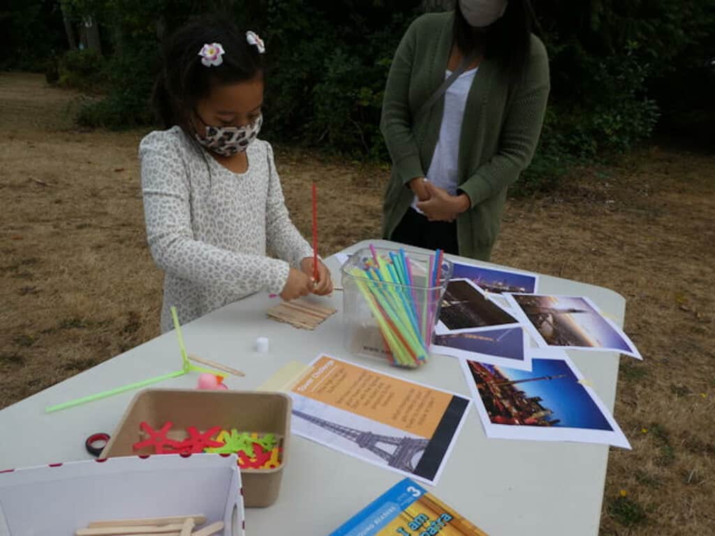 Emerson Delapalma, 7, concentrates on building her tower during a recent STEAM session at the Gig Harbor library.