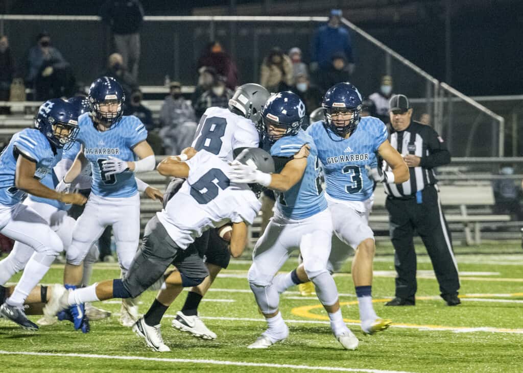Gig Harbor defenders surround a River Ridge ball carrier.