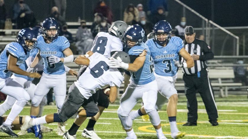 Gig Harbor defenders surround a River Ridge ball carrier.