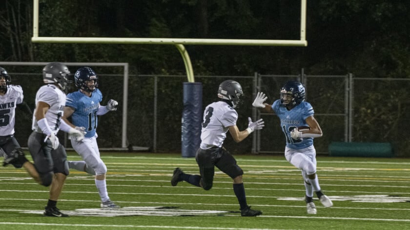 Gig Harbor's Colton Oyster stiff-arms a River Ridge defender.