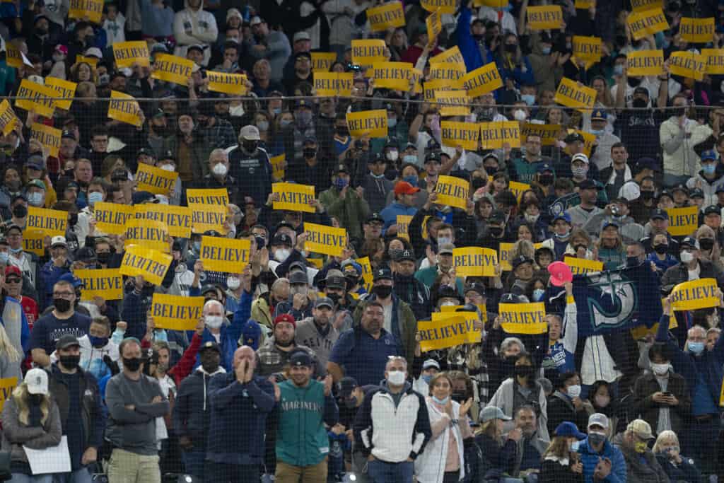 Mariners fans hold yellow Believe placards at T-Mobile Field