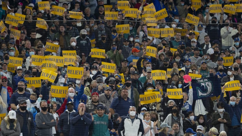 Mariners fans hold yellow Believe placards at T-Mobile Field