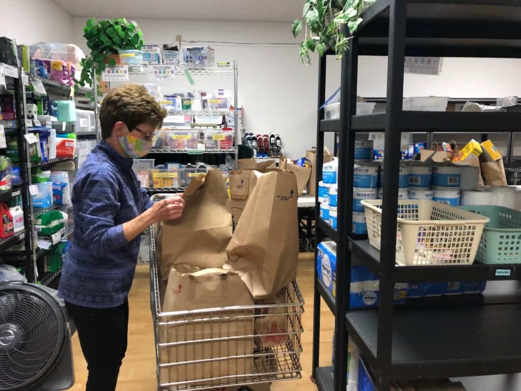 FISH volunteer Judy Kafka fills a client’s wish list with items from the food bank. Kafka has been a FISH volunteer for 18 years.