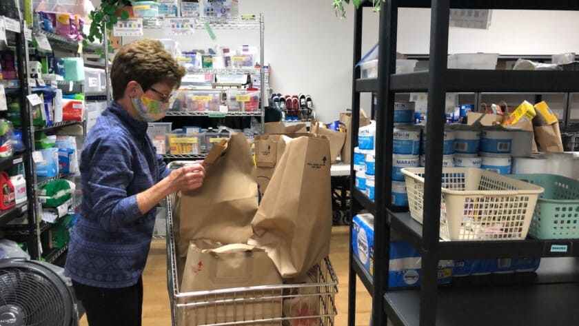 FISH volunteer Judy Kafka fills a client’s wish list with items from the food bank. Kafka has been a FISH volunteer for 18 years.
