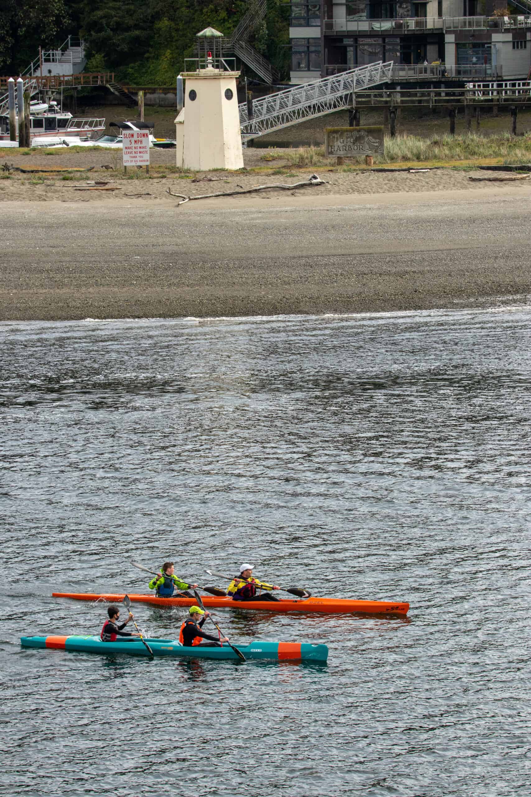 Aaron Laird, Mike Peterson and their sons paddling out of the harbor.