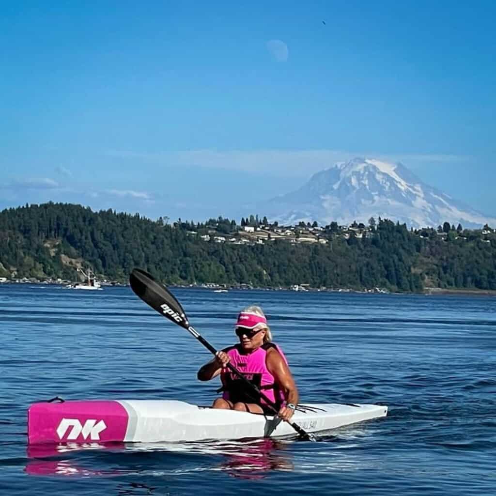Linda Murdock practices in her surfski in the Tacoma Narrows. Mount Rainier in background.