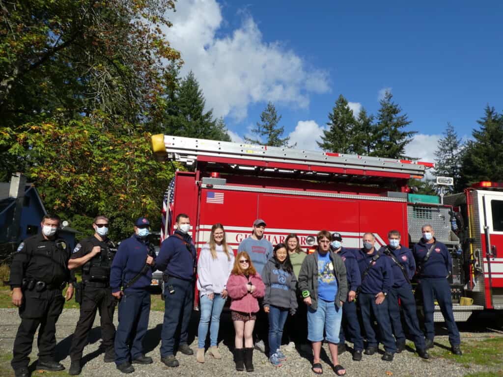Oliver Colglazier (center in blue T-shirt and jacket) with his teachers and classmates from CTP, Gig Harbor police officers and firefighters.