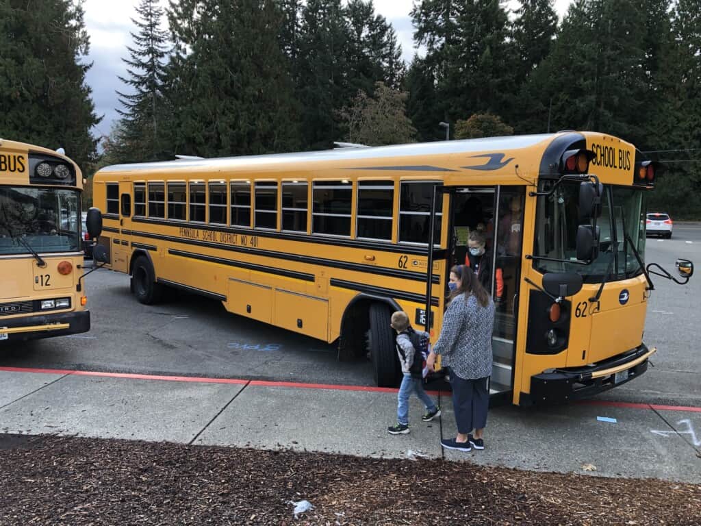 Students get off a bus at Gig Harbor High School.