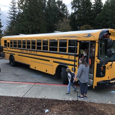 Students get off a bus at Gig Harbor High School.