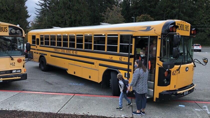 Students get off a bus at Gig Harbor High School.