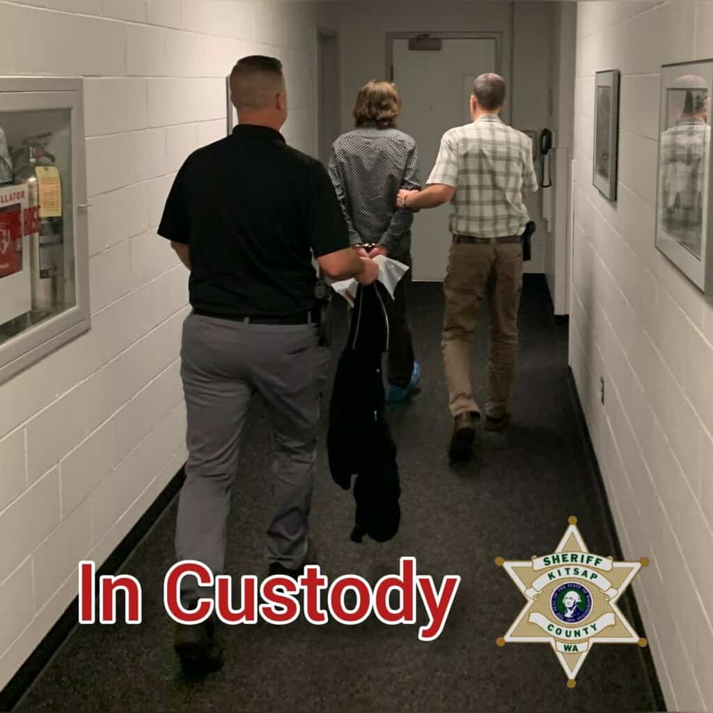 Detectives escort Eli Gregory after he turned himself in
