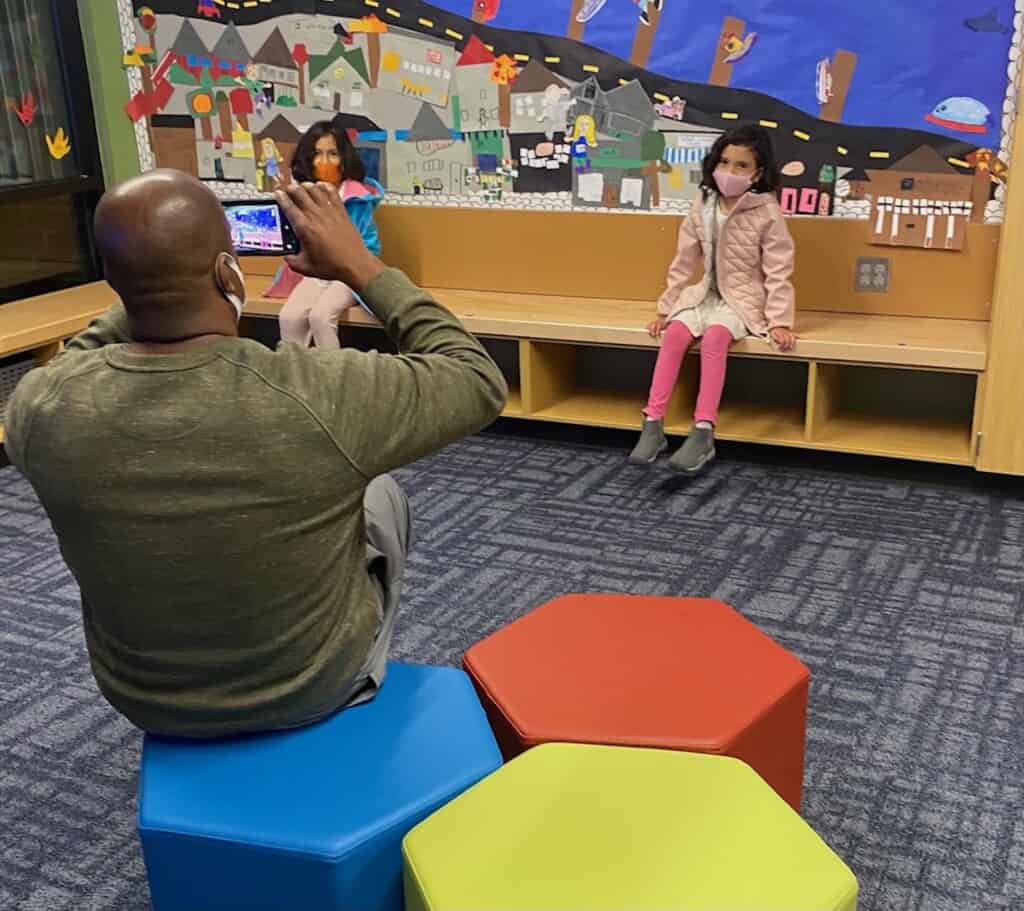 Swift Water Elementary School students Luana and Samara Moss, 7, pose for their father Roger Moss during an open house at the school.