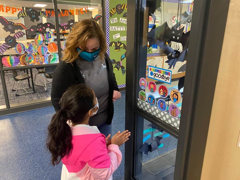 Swift Water Elementary School second-grade teacher Stacy Bigger and student Aryana Sharma admire paper bats in their classroom during an open house at the school.