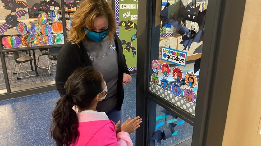 Swift Water Elementary School second-grade teacher Stacy Bigger and student Aryana Sharma admire paper bats in their classroom during an open house at the school.