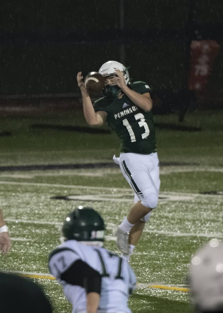 Peninsula's Austin Hansen grabs a pass.