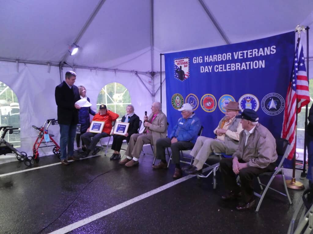 Emcee Greg Copeland with the local veterans who were honored at the Veterans Day event: from left — Hugh McMillan, Georgia Doane, Al Watts, Chuck Meacham, Jack Day and Wally Comman