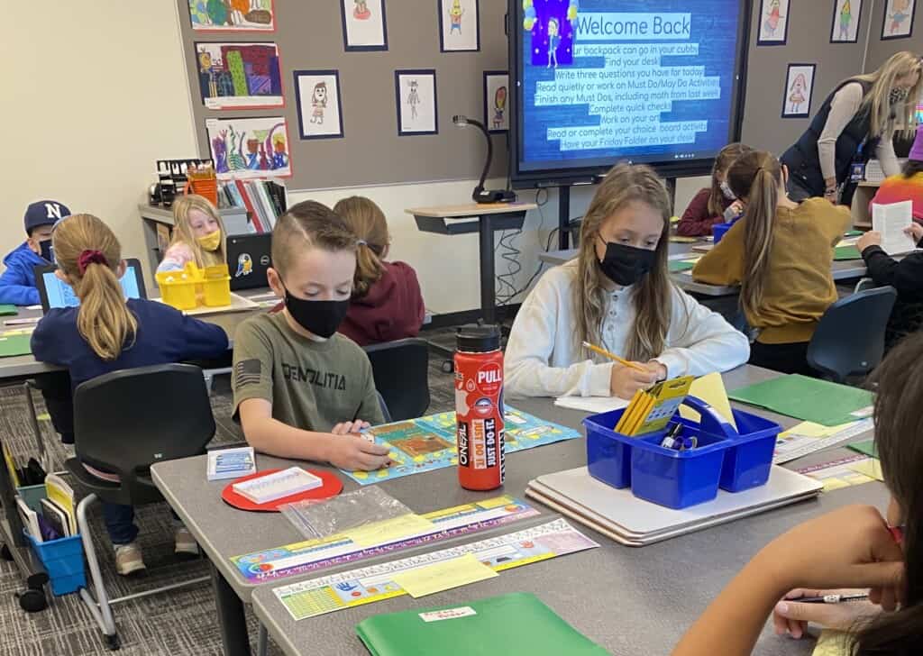 Sawyer Jensen and Haley Kallenberger work on an assignment in Ms. Lily Page’s class at the newly constructed Artondale Elementary School building, on Nov. 22, 2021, the first day of classes in the new building.