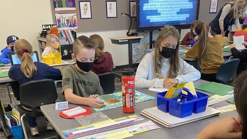 Sawyer Jensen and Haley Kallenberger work on an assignment in Ms. Lily Page’s class at the newly constructed Artondale Elementary School building, on Nov. 22, 2021, the first day of classes in the new building.