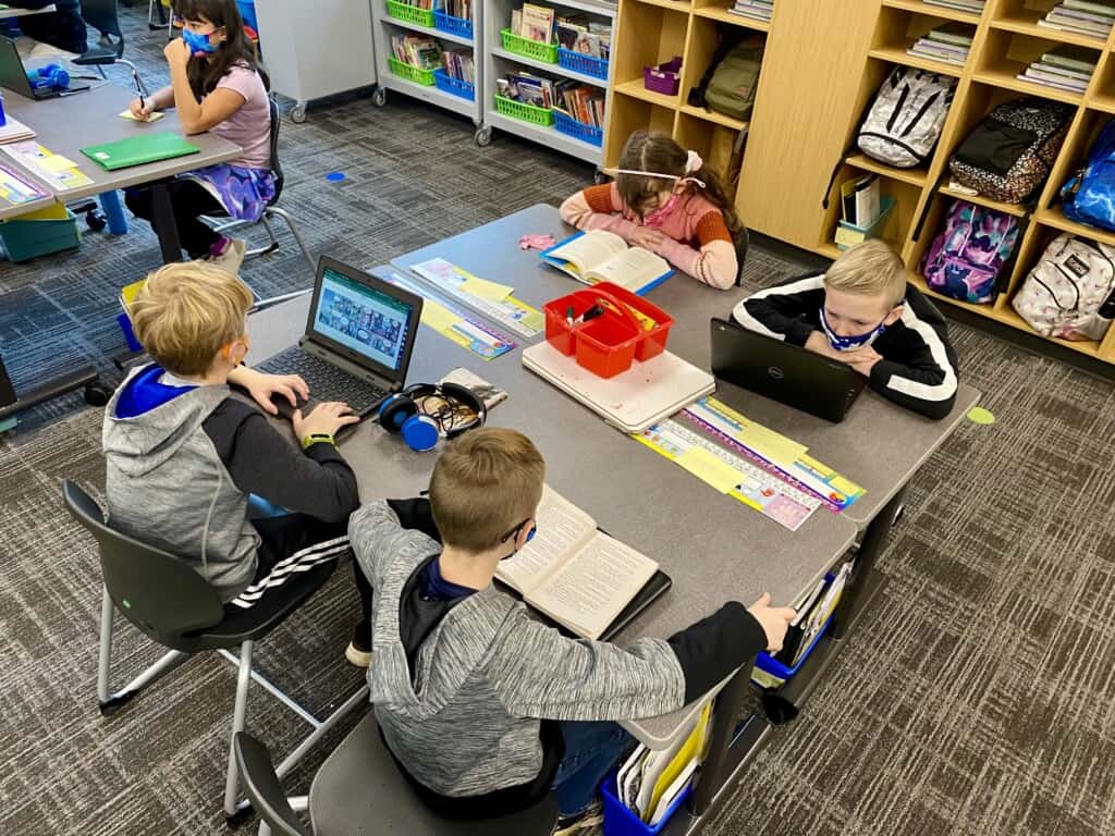 Students in Ms. Lily Page’s class work on an assignment at the newly constructed Artondale Elementary School building, on Nov. 22, 2021, the first day of classes in the new building. The old Artondale Elementary will be demolished and a play field built in its place.