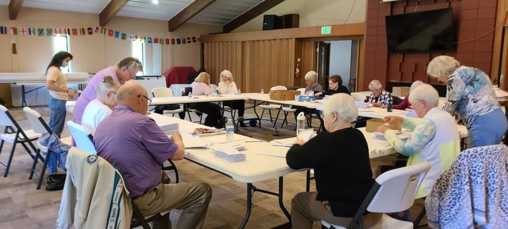 Senior Center members engaged in an activity around a table.
