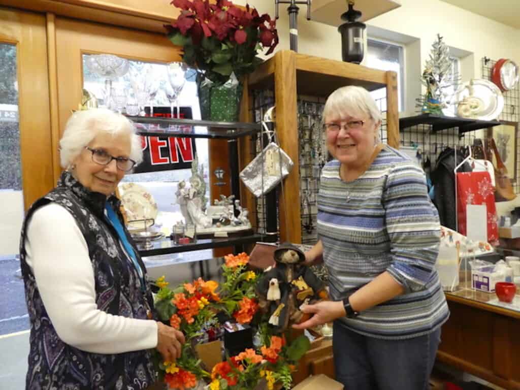 Wanita Martinelli, left, has volunteered at the shop for 14 years. Newcomer Charlotte Yordy joined the group a year ago, after shopping at the store for 20 years.