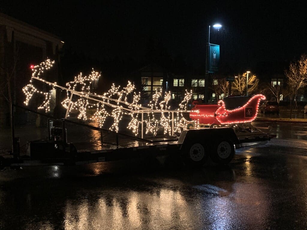 Santa, sleigh and reindeer lit up for the lighted car parade