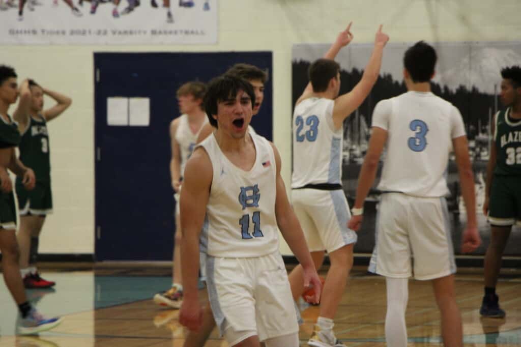 Christian Parrish (11) whoops it up after his Tides defeated Timberline 73-71 Wednesday.