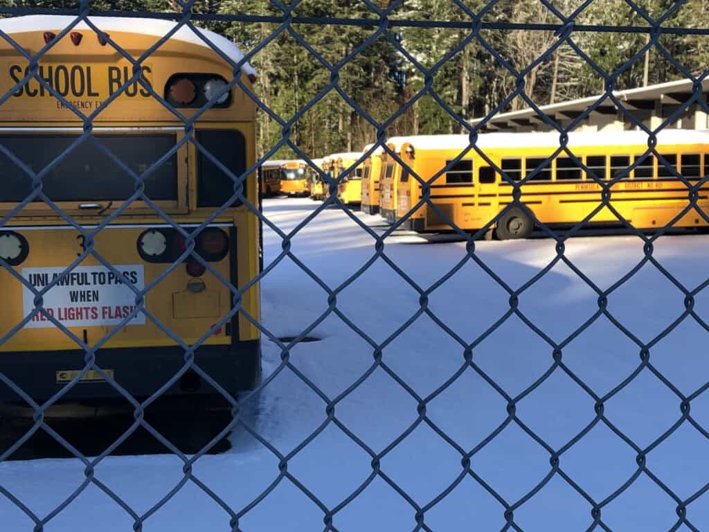Buses parked at Peninsula School District's snowy bus barn