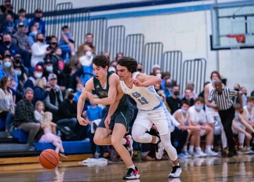 Christian Parrish and Luke Benoit compete for a loose ball