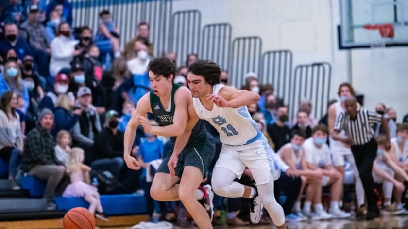 Christian Parrish and Luke Benoit compete for a loose ball