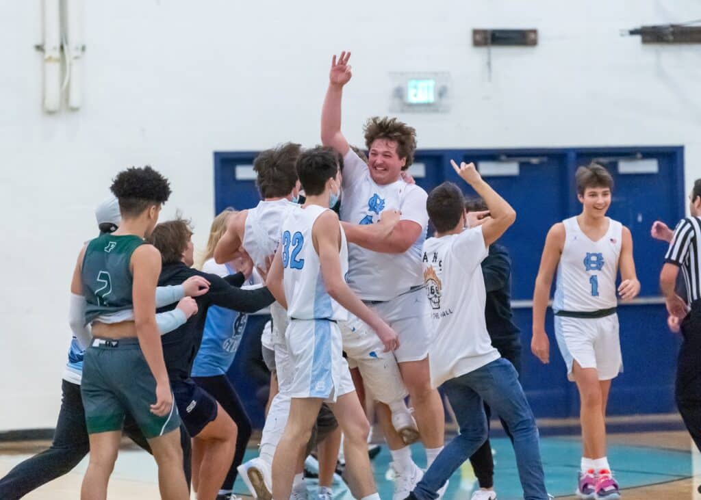 Nic Fortney celebrates his first career 3 as he is mobbed at center court