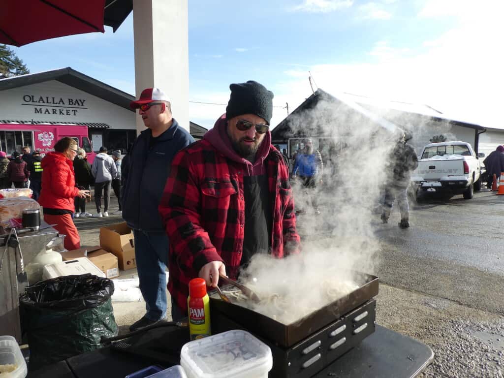 Guy Storz-co-owner of HauteDogs, readies the onions for dressing the hotdogs