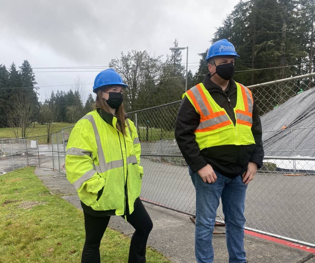 Shannon Gillespie, left, and her father Patrick Gillespie, Peninsula School District’s director of facilities, watch the demolition of the old Artondale Elementary School on Monday. Shannon, 20, now a college student, formerly attended Artondale Elementary. Her last year there was 2012. 