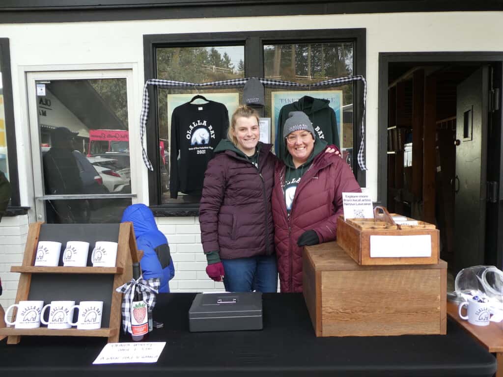 Marta Olson Drevniak & Chris Renfro did steady business selling polarbear merchandise and signing jumpers' certificates