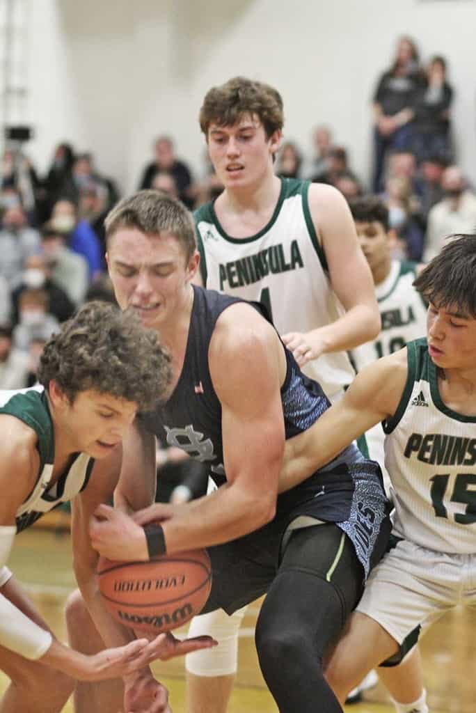 Peninsula's Gabe Sarno and Cole Bashaw (15) knock the ball from Gig Harbor's Parker Born.