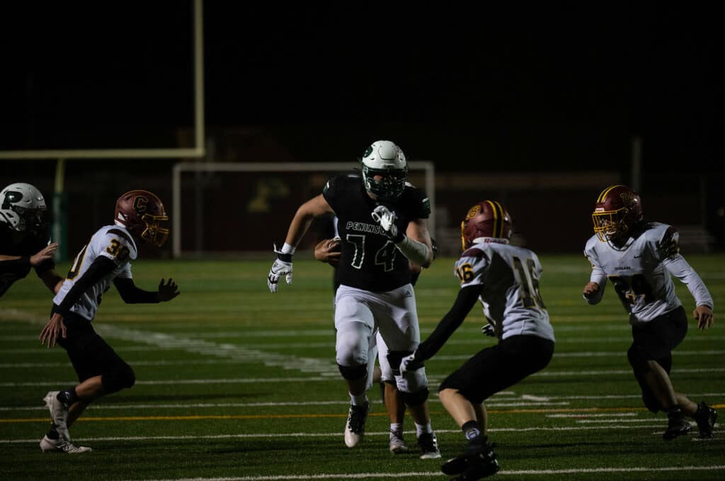 Hall Schmidt looks like a man among boys while blocking against Capital High.