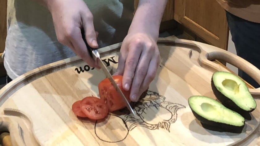 Mason Litts, a seventh grader at Key Peninsula Middle School, prepares nachos for his family’s dinner.