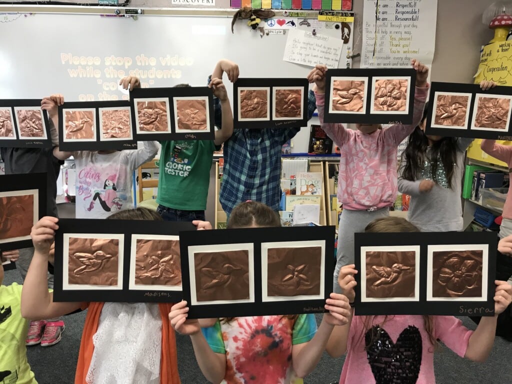 Kids display the artwork they created during Hands on Art program