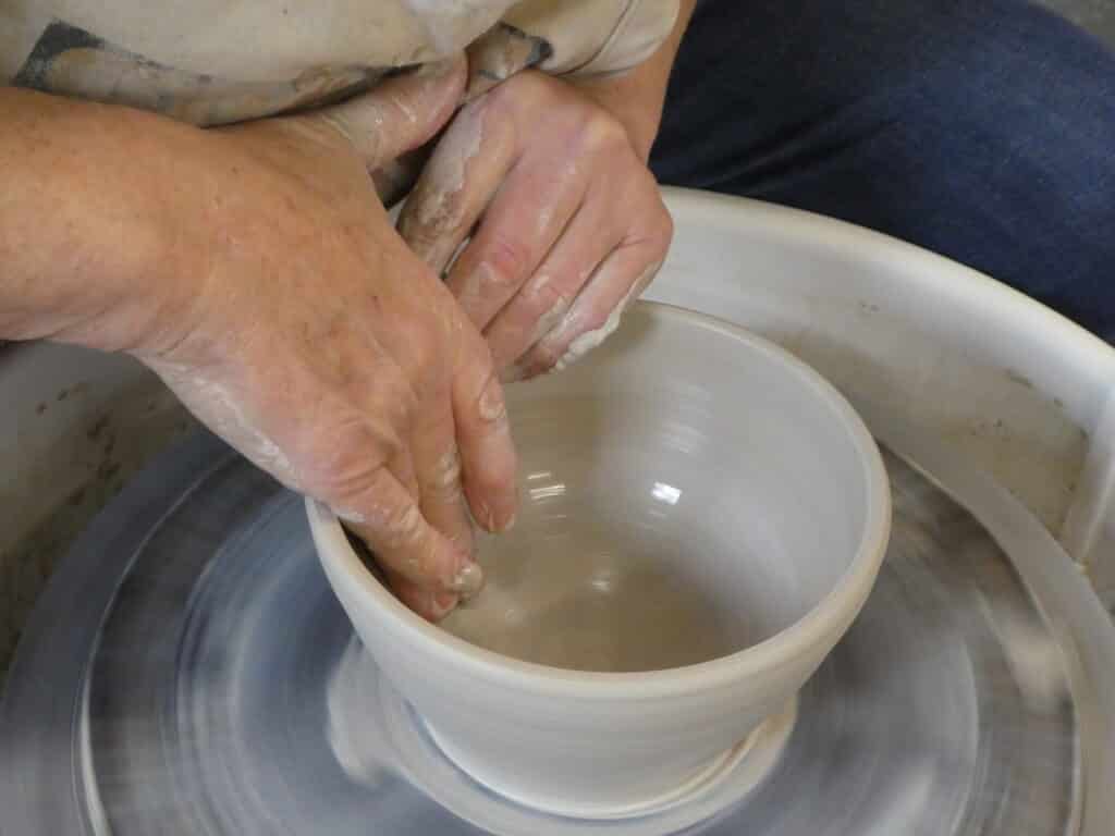 Olalla potter Jana Fisher finishes a bowl for the Empty Bowls event. A dozen local potters have cntributed hand-thrown pots to this year's event
