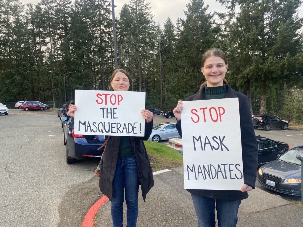 Jacqueline Emory, right, and her mother, Glenda Emory, protest against the state’s school mask mandate Wednesday at Peninsula High School.